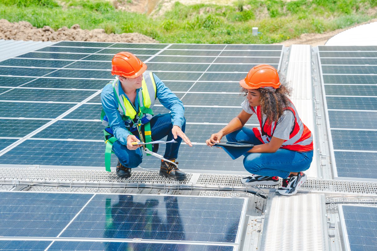 Male engineering teams install solar panels at solar power generating station, Professional engineer installing photovoltaic panel system using screwdriver, green energy and sustainable living