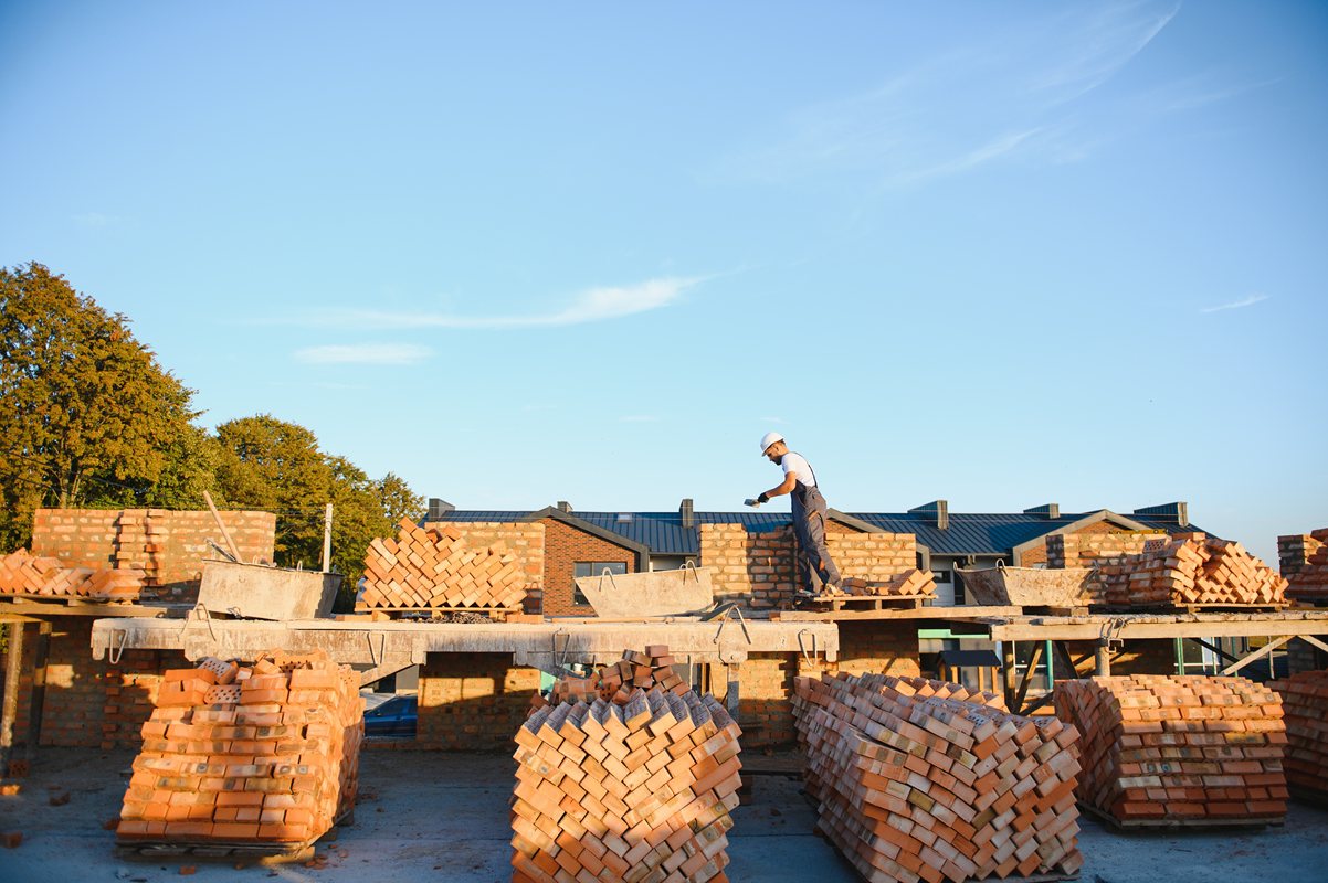 surveyor setting out for brickwork on construction site