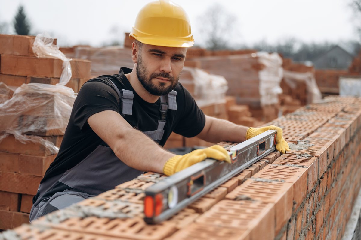 surveyor setting out and levelling for brickwork
