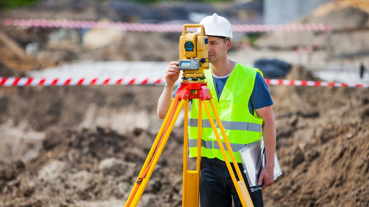 man doing a digital survey of land